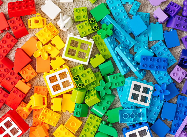 Large LEGO duplo pieces stacked in rainbow colours.