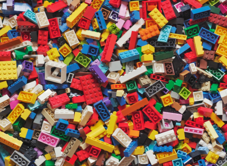 Lots of different shaped and coloured LEGO blocks spread out.
