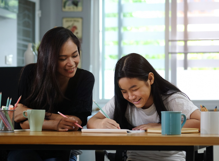Photo of parent and child studying together.