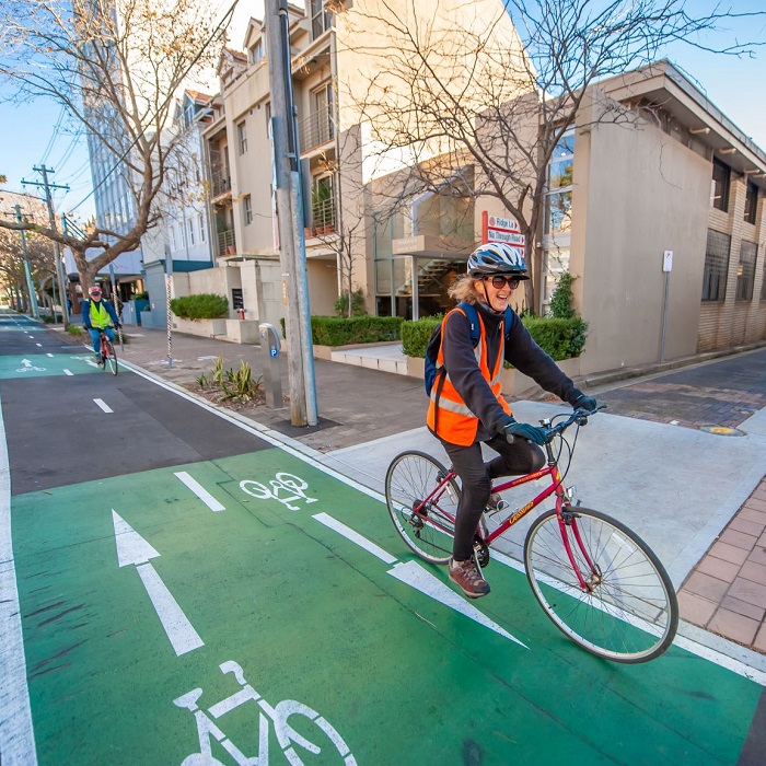 Two cyclists riding bikes on a cycleway