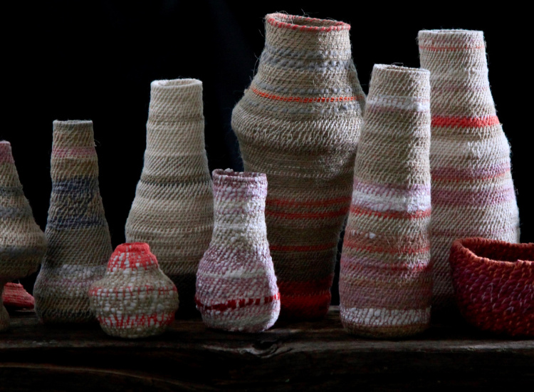 Felted vessels on black background