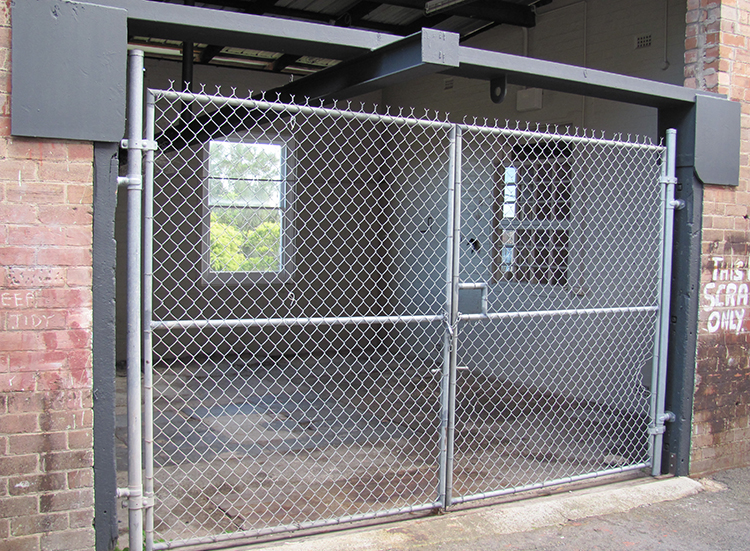 Large metal gate showing inside into studio space