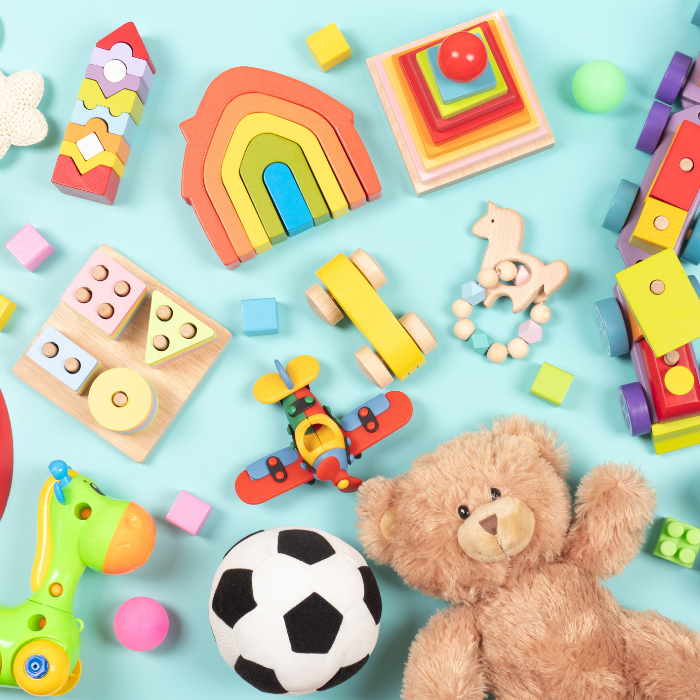 A collection of children&#039;s toys including blocks and teddy bear