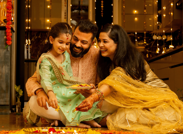 Photo of a man, woman and young girl dressed in traditional Indian garb.