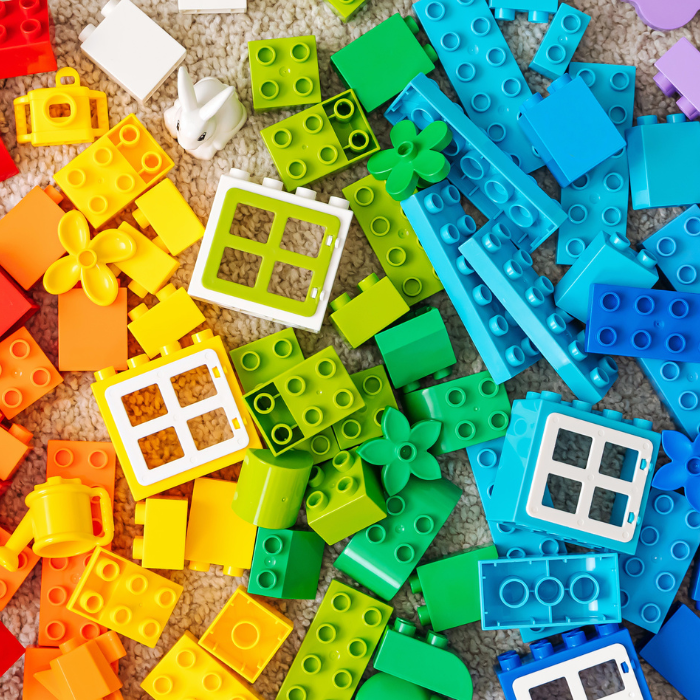 Large LEGO duplo pieces stacked in rainbow colours.