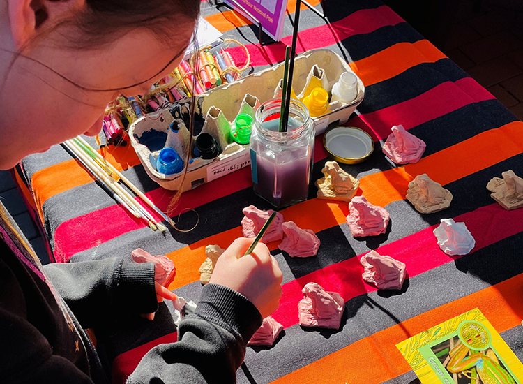 child painting small figurines
