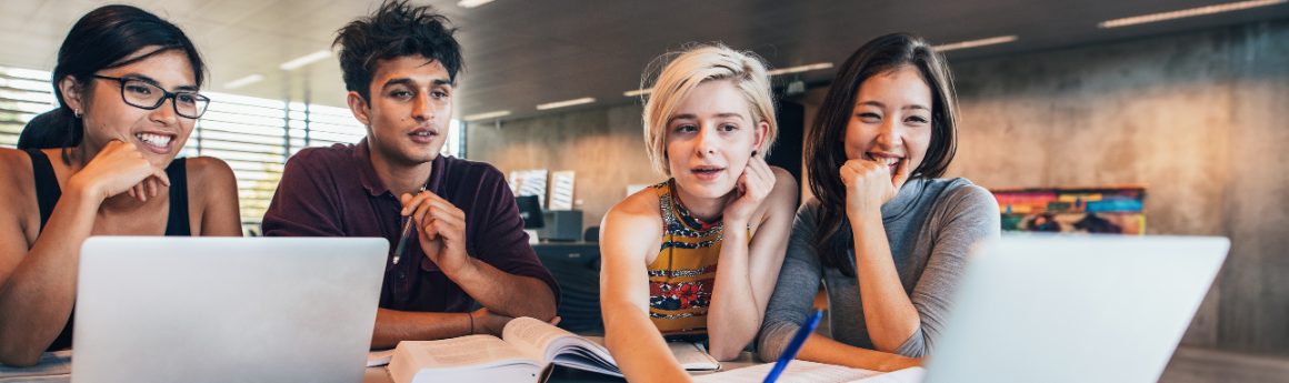 4 young adults sitting together studying from a laptop