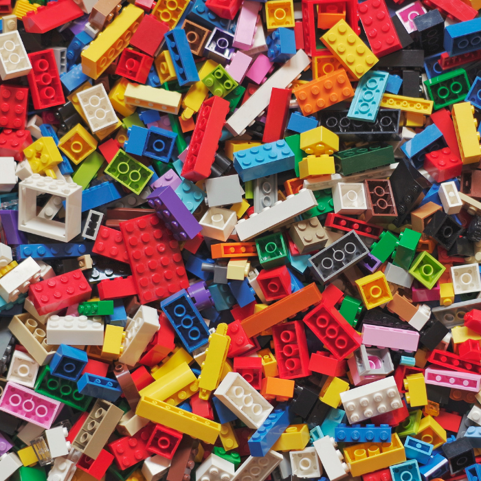 Lots of different shaped and coloured LEGO blocks spread out.