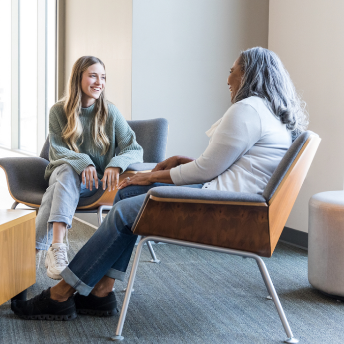 Two women sitting and chatting to each other