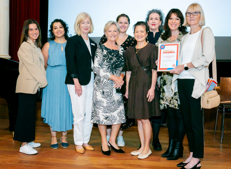 Marys House volunteer team picture holding their Community Builder Award with Mayor Zo&euml; Baker