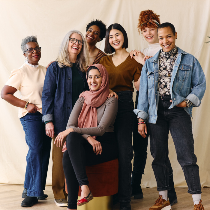 Image of a group of multicultural women standing together happily