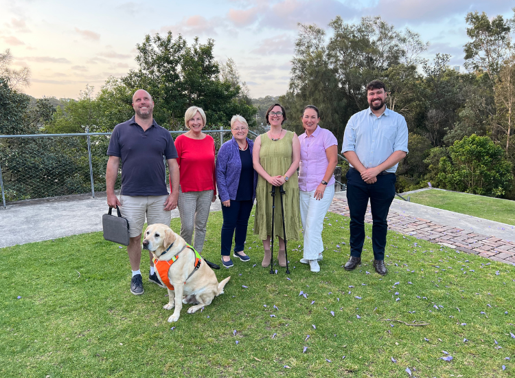 Members of Council&#039;s Access and Inclusion Committee posing for a photo with a guide dog.