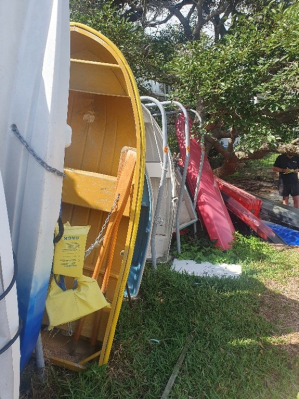 Boats stored in a row on grass