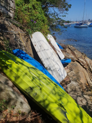 Boats leaning against a rock wall