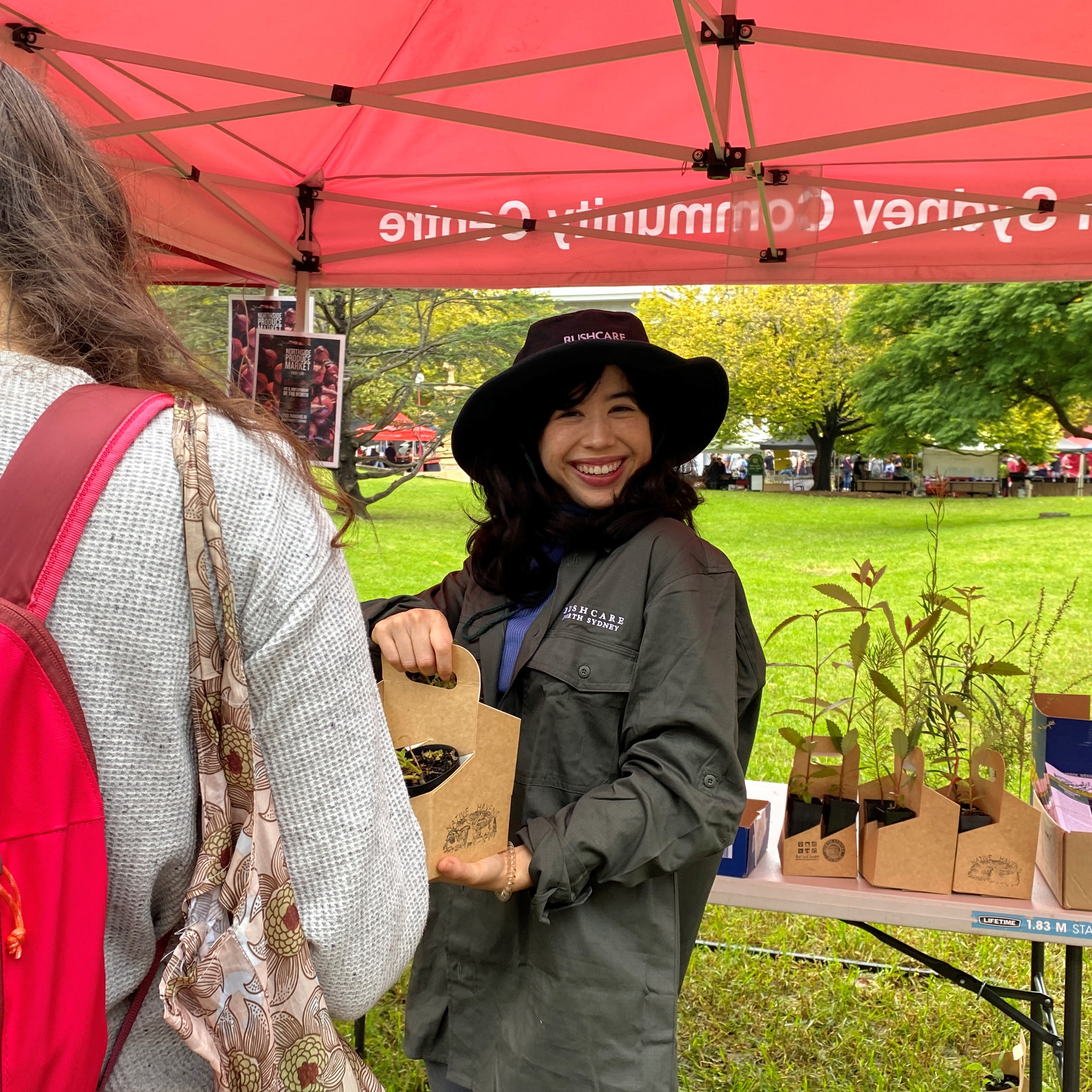 Siobhan staffing the Bushcare Stall at the Produce Markets