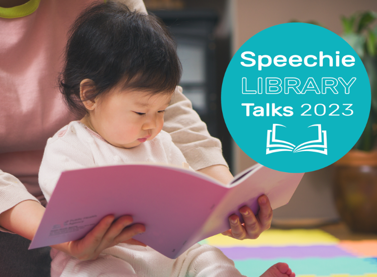 An infant reading a book while seated in parents lap. &#039;Speechie Library Talks 2023&#039; logo