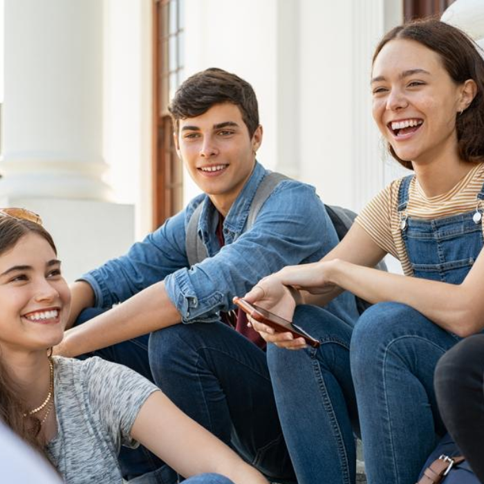 Group of young people sitting together and talking