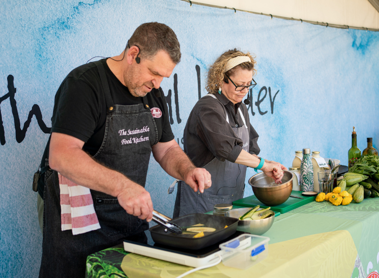 Man and woman cooking wearing aprons
