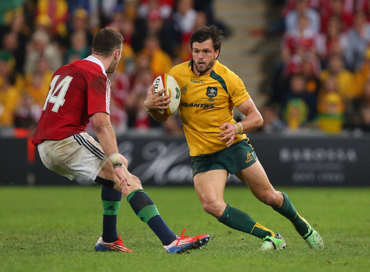 Wallabie&#039;s player Adam Ashey- Cooper holding ball mid run
