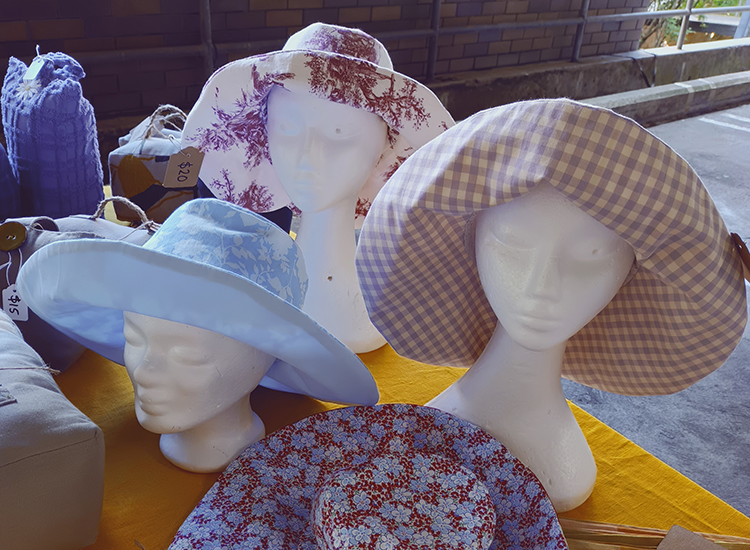 three mannequin heads wearing hats