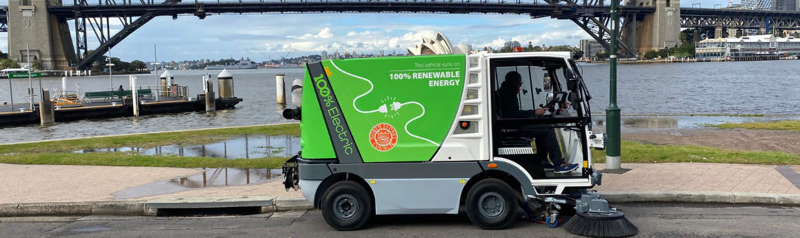 street sweeper machine parked on road in front of McMahons Point ferry jetty.