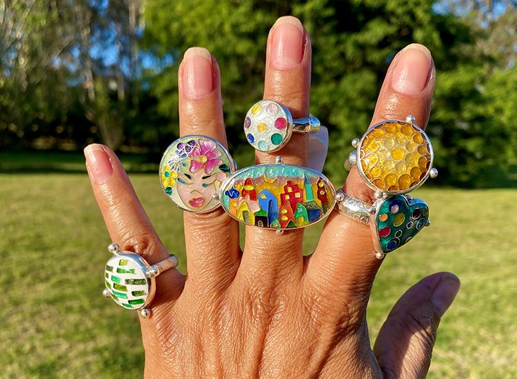 hand displaying six different colourful rings